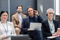 Mature businessman in headset holding laptop Royalty Free Stock Photo