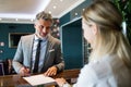 Mature businessman at hotel reception. Royalty Free Stock Photo