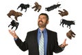 Mature Businessman Juggling Bears and Bulls