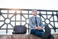 Mature businessman with a laptop in a city. Royalty Free Stock Photo