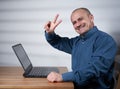 Mature businessman with laptop at his desk Royalty Free Stock Photo