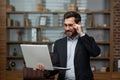 Mature businessman lawyer works in office waiter uses laptop, senior boss in glasses and business suit smiling man Royalty Free Stock Photo