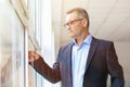 Mature businessman near window in office Royalty Free Stock Photo