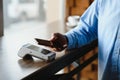 Mature businessman paying with contactless credit card with NFC technology. Royalty Free Stock Photo