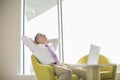 Mature businessman relaxing in lobby Royalty Free Stock Photo