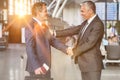 Mature businessman shaking hands with business partner in airport Royalty Free Stock Photo