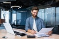 Mature businessman in shirt doing paperwork, man working with documents, contracts and bills sitting at table using Royalty Free Stock Photo