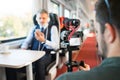 Mature businessman with smartphone travelling by train. Royalty Free Stock Photo