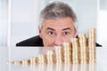 Mature businessman with stack of coins