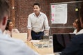 Mature Businessman Standing And Leading Office Meeting Around Table Royalty Free Stock Photo