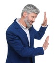 Mature businessman in stylish clothes avoiding something on white background Royalty Free Stock Photo