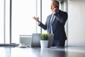 Mature businessman talking on a mobile phone standing near the window Royalty Free Stock Photo