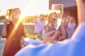 Mature businessman toasting wineglass with colleagues during success party on rooftop