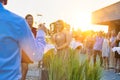 Mature businessman toasting wineglass with colleagues during success party on rooftop