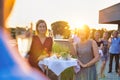 Mature businessman toasting wineglass with colleagues during success party on rooftop