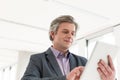 Mature businessman using tablet computer in new office Royalty Free Stock Photo