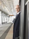 Mature Businessman Waiting At Empty Train Station Royalty Free Stock Photo