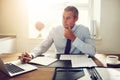 Mature corporate executive working at his desk in an office