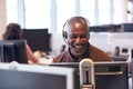 Mature Businessman Wearing Telephone Headset Talking To Caller In Customer Services Department Royalty Free Stock Photo