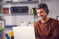 Mature Businessman Wearing Telephone Headset Talking To Caller In Customer Services Department Royalty Free Stock Photo