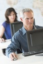 Mature Businessman Working On Computer In Office Royalty Free Stock Photo