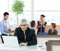 Mature businessman working in office hallway Royalty Free Stock Photo