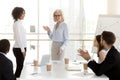 Mature businesswoman introducing new worker to colleagues