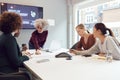 Mature Businesswoman Leading Creative Meeting Of Women Collaborating Around Table In Modern Office Royalty Free Stock Photo