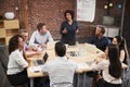 Mature Businesswoman Standing And Leading Office Meeting Around Table Royalty Free Stock Photo