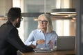 Mature businesswoman talking with business partner in office Royalty Free Stock Photo