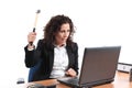 Mature businesswoman trying to destroy a laptop with a hammer