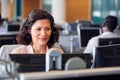 Mature Businesswoman Wearing Telephone Headset Talking To Caller In Customer Services Department Royalty Free Stock Photo