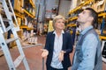 mature businesswoman with worker in warehouse Royalty Free Stock Photo