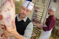Mature butcher working in butchery