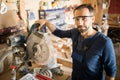 Mature Carpenter Posing with Cutting Machine Royalty Free Stock Photo