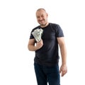 Mature casual man in jeans and a T-shirt with money, dollars in hand isolated on white background. Profit, wealth, winning the Royalty Free Stock Photo