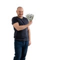 Mature casual man in jeans and a T-shirt with money, dollars in hand isolated on white background. Profit, wealth, winning the Royalty Free Stock Photo