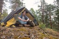 Mature caucasian man sitting in camping near tent after walking