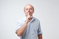 Mature caucasian man wearing blue shirt making silence gesture. Royalty Free Stock Photo