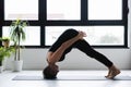 Mature Caucasian woman practicing yoga on livingroom floor Royalty Free Stock Photo