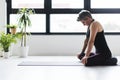 Mature Caucasian woman practicing yoga on livingroom floor Royalty Free Stock Photo