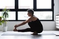 Mature Caucasian woman practicing yoga on livingroom floor Royalty Free Stock Photo