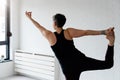 Mature Caucasian woman practicing yoga on livingroom floor Royalty Free Stock Photo