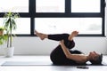 Mature Caucasian woman practicing yoga on livingroom floor Royalty Free Stock Photo