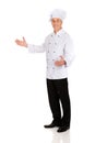 Mature chef holding empty space in hands