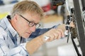 Mature competent bicycle mechanic in workshop Royalty Free Stock Photo
