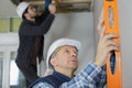 Mature construction worker using level Royalty Free Stock Photo