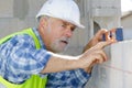 Mature construction worker using level Royalty Free Stock Photo
