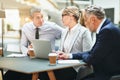 Mature corporate collegues working together in an office lobby