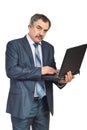 Mature corporate man working on laptop